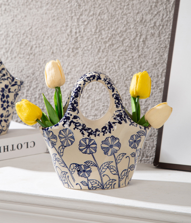 Close-up of sturdy handle and vintage rustic glaze on ceramic tote bag vase
