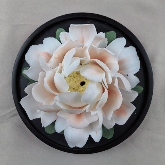 Hand-sculpted white ceramic peony aroma diffuser on black resin base