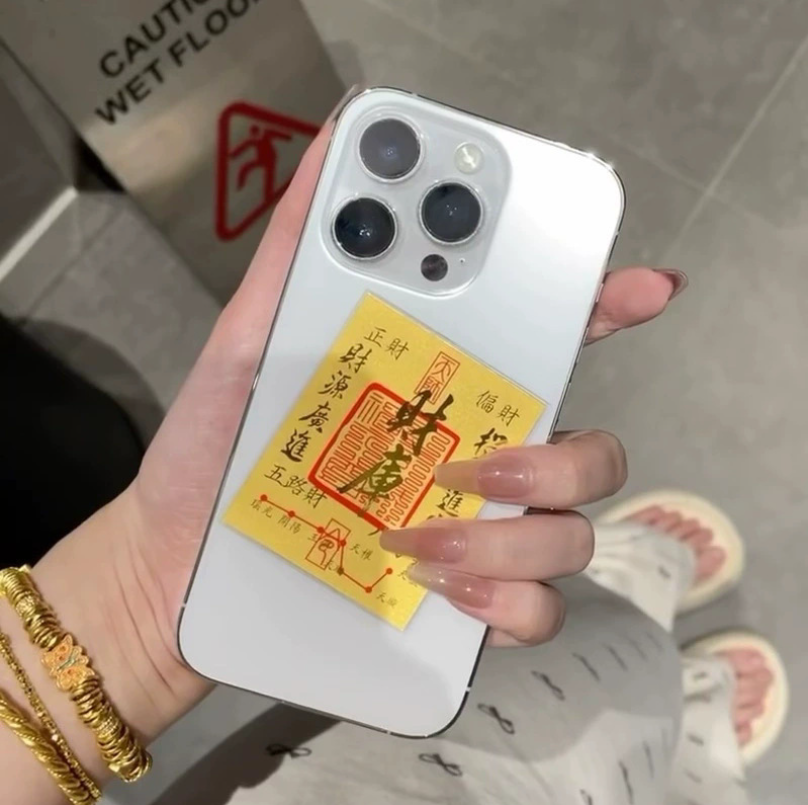 Wealth talisman placed inside a phone case for constant luck