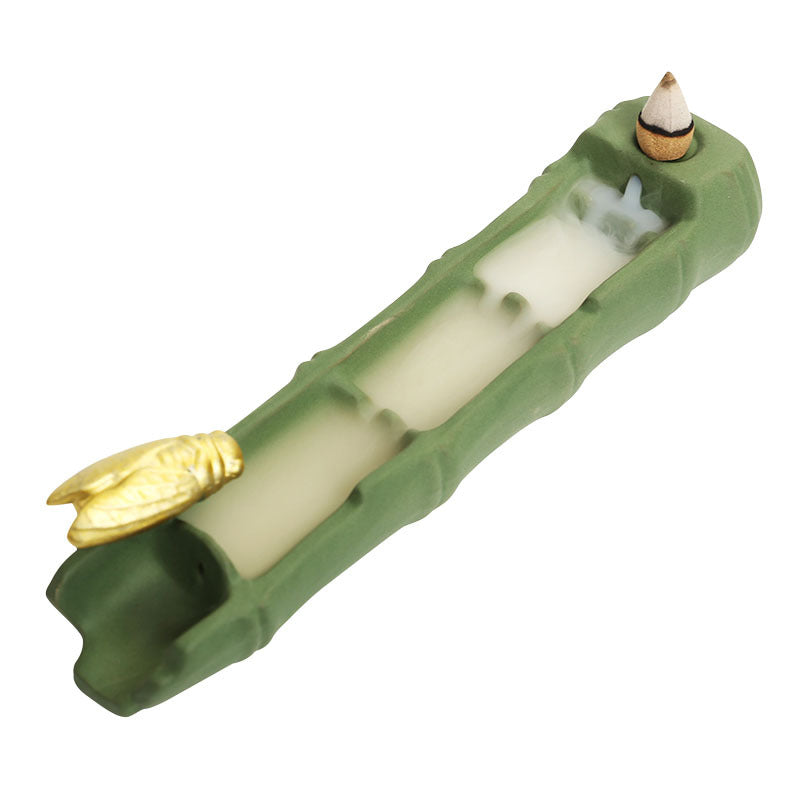 Celadon bamboo ceramic incense burner with golden cicada on white background