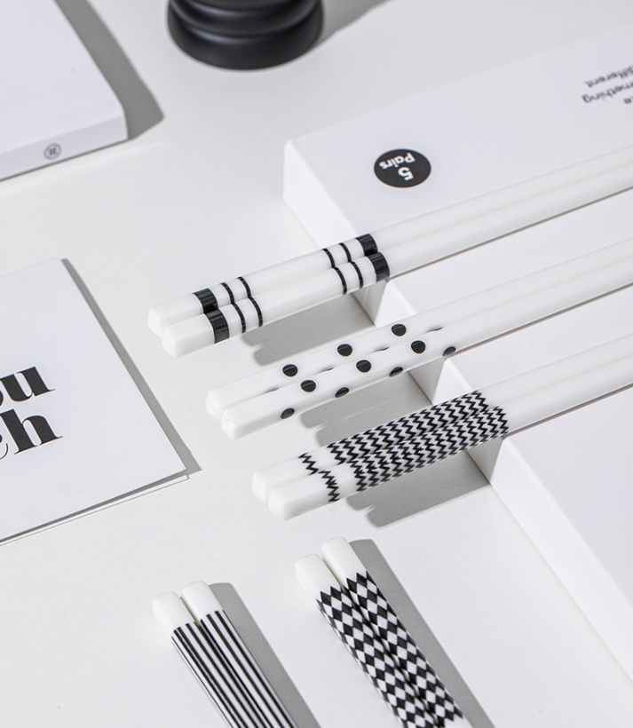 Close-up of non-slip textured tip on white ceramic chopsticks, showing high-fired durable porcelain material safe for picking up sushi and noodles
