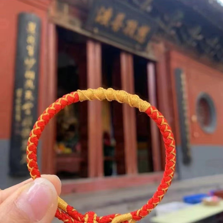 Handwoven red string bracelet with gold accents for Yue Lao love luck and marriage blessing