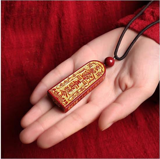 Traditional Taoist protection symbols carved on Cinnabar amulet